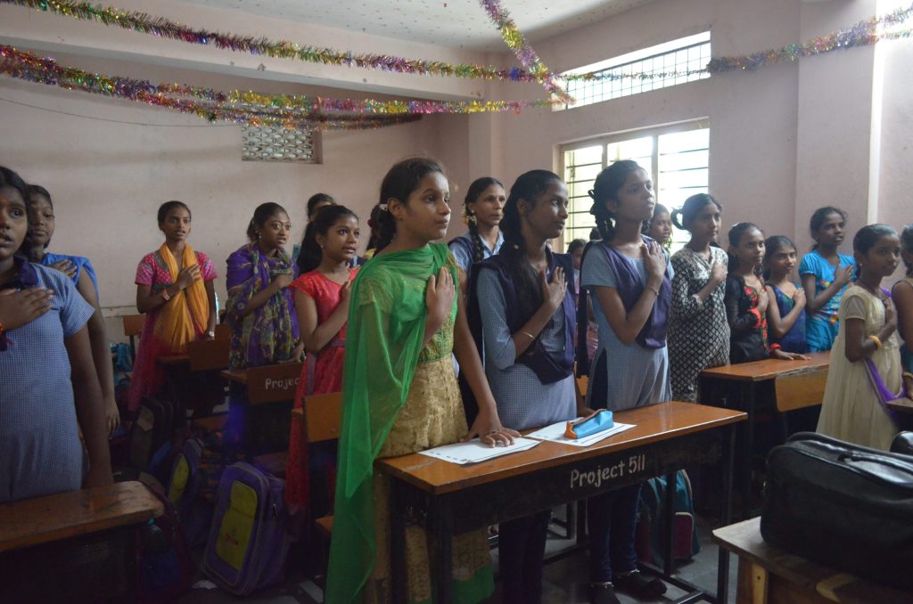 students taking the pledge during menstrual education session